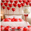 Romantic birthday room decoration with red heart helium balloons and love theme setup