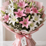 Pink and white Oriental lily bouquet with 20 stems, wrapped in pink paper with a satin ribbon, available in Delhi NCR from BloomBoxs.