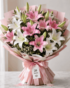 Pink and white Oriental lily bouquet with 20 stems, wrapped in pink paper with a satin ribbon, available in Delhi NCR from BloomBoxs.