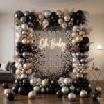 Luxe gold, black and silver baby shower balloon decoration with sequin backdrop and Oh Baby sign in Delhi NCR