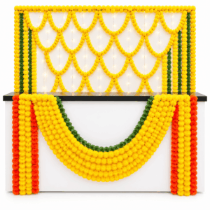 Reception counter decorated with fresh yellow marigold flower garlands, orange floral strings and green leaves in Delhi NCR